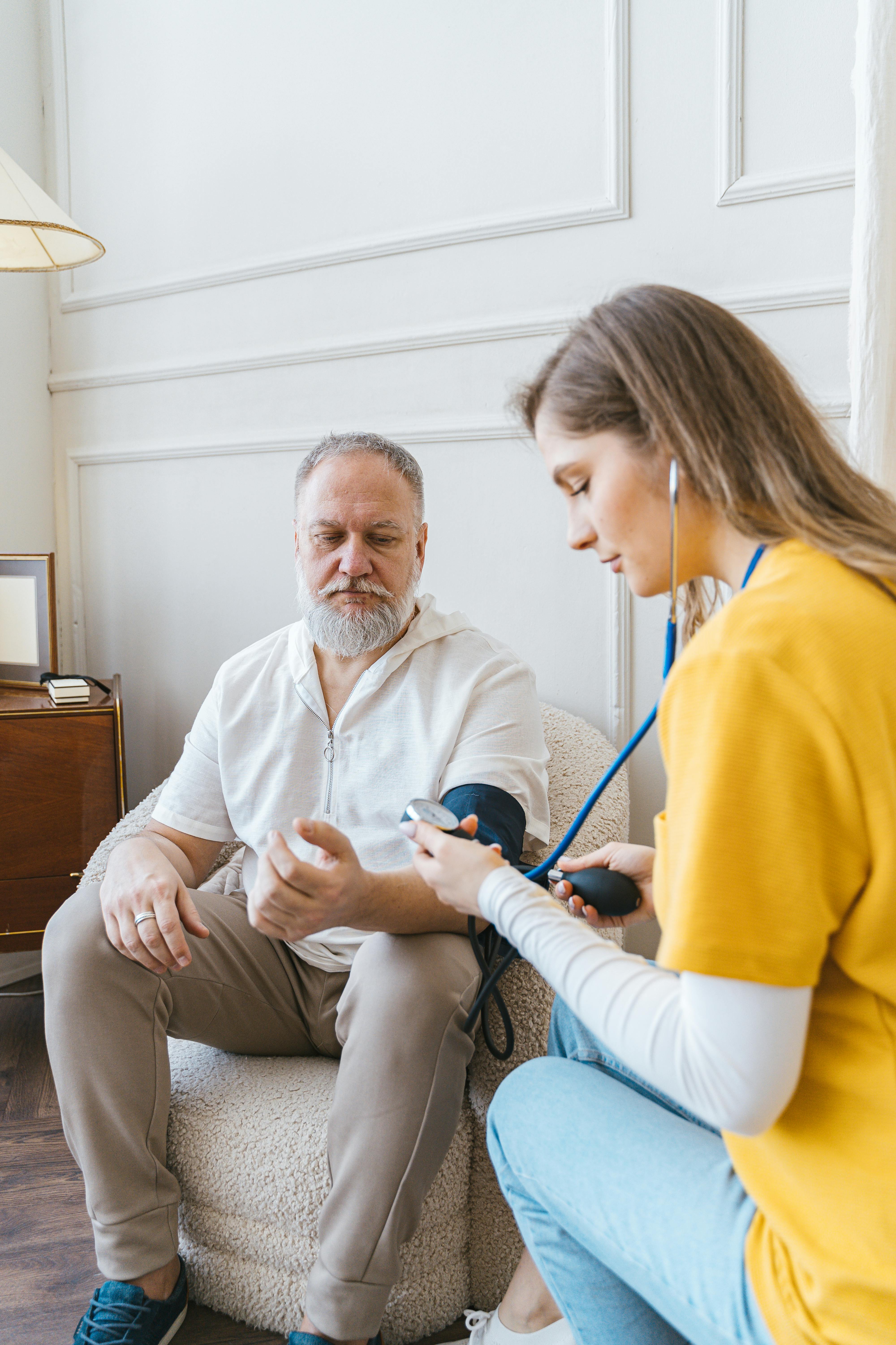 Healthcare provider checking patient's blood pressure